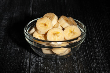 sliced banana bowl on black wood background - 771525371
