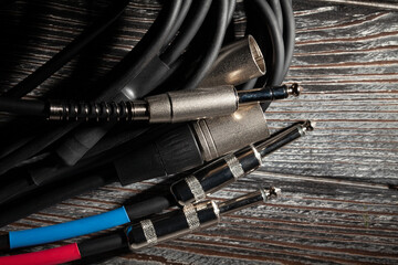 audio xlr trs cable plugs on wood background