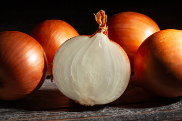 sliced onions on black wood background