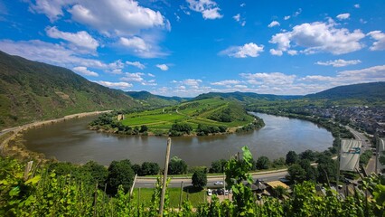 the view from the hill with a river and mountains in the background