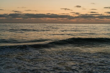 Obraz premium Surreal sunset over the ocean with a pristine sky.