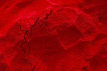 Fotobehang a red, cracked piece of rock with cracked cracks © Wirestock