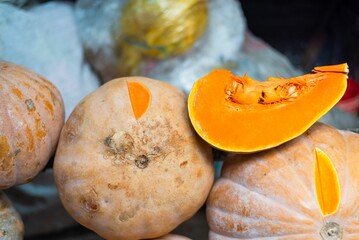Pumpkins with a cut slice in the market for sale