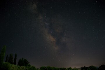 Naklejka na ściany i meble closeup of a tranquil long-exposure image of a starry night sky above a small stream