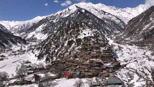 Scenic Kalasha Village in Bamburet Valley in North Pakistan at Winter. Aerial View Hindu Kush Muntain Range Himalayas.