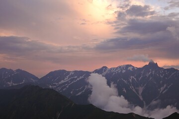 Scenic view of a mountain range at sunset