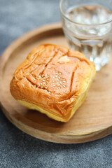Bluder Bread (Bloeder Bread) with Mineral Water. Is a type of classic Indonesian bread.
