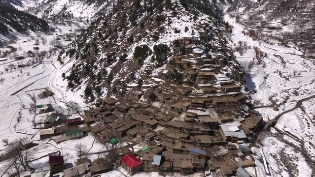 Scenic Kalasha Village in Bamburet Valley in North Pakistan at Winter. Aerial View Hindu Kush Muntain Range Himalayas.