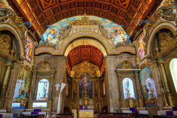 Fototapeta na wymiar elaborate ornate church interior depicting religious scenes showing the alter and portico's