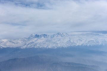 Fototapeta na wymiar Aerial view of the snow-capped Ten-Zan Bodga peak