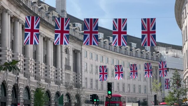 Panoramic view of Regent road street in central London with British flags handing along the street on sunny summer day