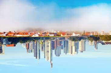 opposite. a village becomes a city. village and city reflected in the water . Urban and non urban Reflections. 