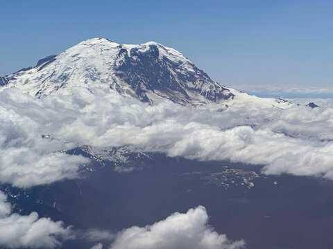 Aerial view of Mount Ranier in snow and clouds in Washington