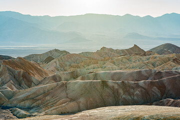 View from Zabriskie Point at dusk. Death Valley National Park in Inyo County of Mojave Desert, California is the hottest place on earth with a temperature of 56,7 °C recorded in 1913. - 771542306