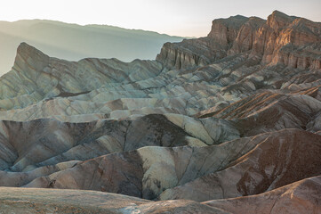 View from Zabriskie Point at dusk. Death Valley National Park in Inyo County of Mojave Desert, California is the hottest place on earth with a temperature of 56,7 °C recorded in 1913. - 771542307