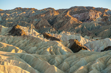 View from Zabriskie Point at dusk. Death Valley National Park in Inyo County of Mojave Desert, California is the hottest place on earth with a temperature of 56,7 °C recorded in 1913. - 771542322