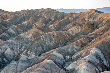 View from Zabriskie Point at dusk. Death Valley National Park in Inyo County of Mojave Desert, California is the hottest place on earth with a temperature of 56,7 °C recorded in 1913. - 771542324