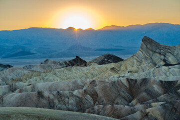 View from Zabriskie Point at dusk. Death Valley National Park in Inyo County of Mojave Desert, California is the hottest place on earth with a temperature of 56,7 °C recorded in 1913. - 771542345