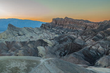 View from Zabriskie Point at dusk. Death Valley National Park in Inyo County of Mojave Desert, California is the hottest place on earth with a temperature of 56,7 °C recorded in 1913. - 771542368