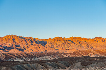 View from Zabriskie Point at dusk. Death Valley National Park in Inyo County of Mojave Desert, California is the hottest place on earth with a temperature of 56,7 °C recorded in 1913.