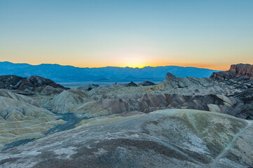 View from Zabriskie Point at dusk. Death Valley National Park in Inyo County of Mojave Desert, California is the hottest place on earth with a temperature of 56,7 °C recorded in 1913. - 771542398