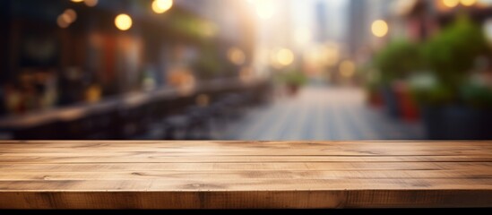 A hardwood plank table with wood stain on the floor, set against a blurry city street backdrop with...