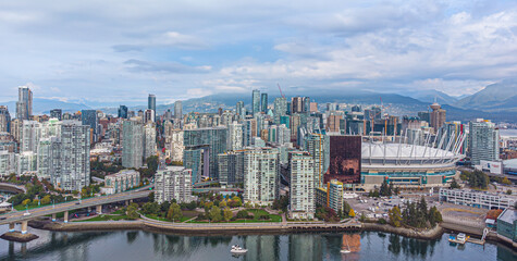 Vancouver, British Columbia, Canada - 4 October 2021: Aerial panoramic view of downtown business centre and BC Place Stadium, with Rocky Mountains in the backdrop. Photo taken by drone.