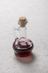 Red wine in a bottle on a white background. Selective focus.
