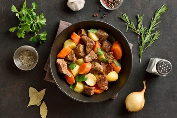 Beef stew with potatoes, carrots and greens. Top view, flat lay