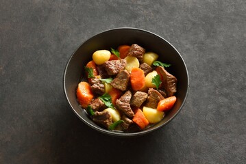 Beef stew with potatoes, carrots and greens