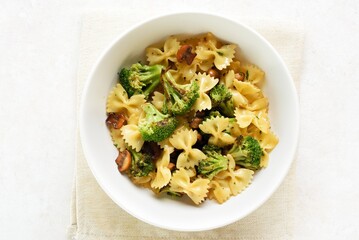 Farfalle pasta with roasted broccoli and mushrooms in bowl