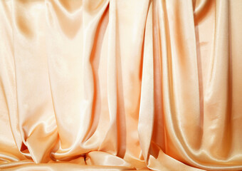 BackdropYellow silk satin  Drape fabric Gold color Luxurious background. Beautiful wavy area for design, blurred or blurred.