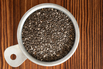 Black Chia Seeds in a Vintage Measuring Cup - 771549179