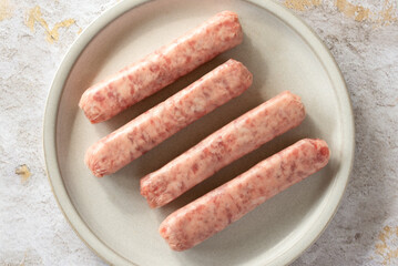 Uncooked Pork Breakfast Sausages on a Plate - 771549525