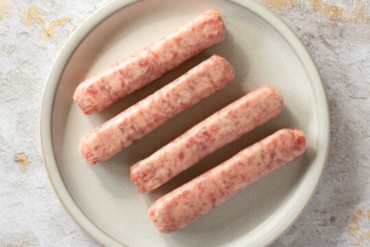 Uncooked Pork Breakfast Sausages on a Plate