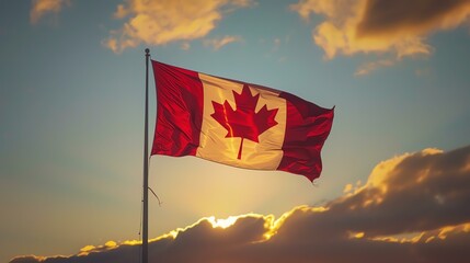 A Canadian flag is waving in the wind. The flag is red and white with a maple leaf in the center.