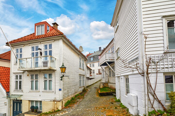 Street with white wooden houses in central Bergen, Norway - 771559766