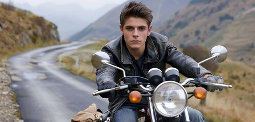 A trendy-haired young man rides a motorcycle along twisting mountain roads with confidence, and the thrill of the ride is caught in high resolution