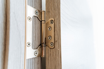 Closeup of a wooden door hinge, a key fixture in household hardware