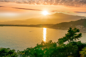 picturesque view to a sunset sea gulf with beautiful mountains and amazing cloudy sky on background of nice travel landscape