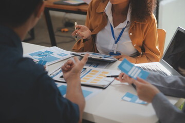 Close up ux developer and ui designer use augmented reality brainstorming about mobile app interface wireframe design on desk at modern office.Creative digital development agency