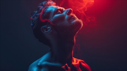 Naklejka premium A man exhaling red smoke, creating a mysterious and intriguing atmosphere.