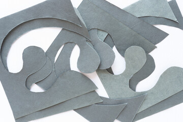 pile of repeating cut paper shapes with wavy curvy elements