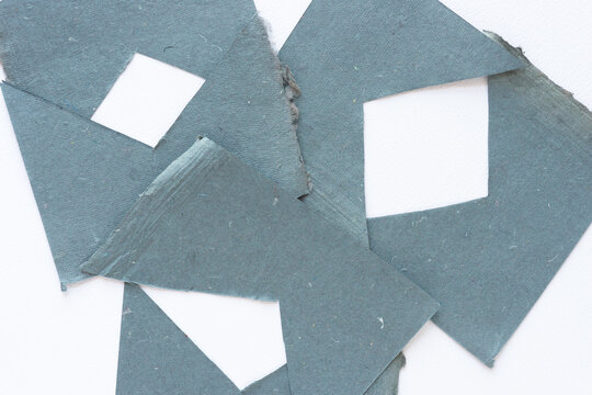 negative space squares or frames composed of gray paper with triangle shape cutouts on blank paper - Powered by Adobe