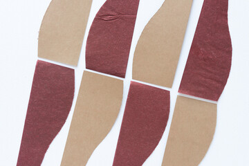 alternating pattern composed of brown and red paper with wavy and straight edges on blank paper