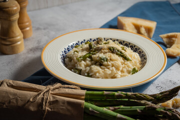 risotto rice with green asparagus and cheese served on table 