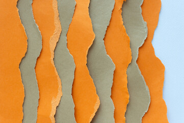stripes of orange and brown paper with ripped and wavy edges