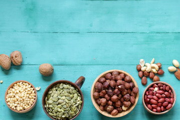 different types of nuts in bowls on the table