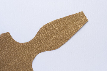abstract shape cut from metallic gold crepe paper