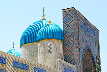 The upper part of the mosque with beautiful turquoise domes and minaret.